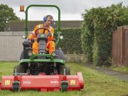 Grounds maintenance, grounds person cutting grass