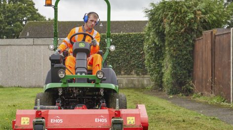 Grounds maintenance, grounds person cutting grass