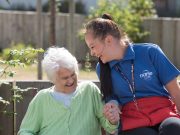NorseCare employee laughing with an elderly resident in one of our Norfolk based residential homes