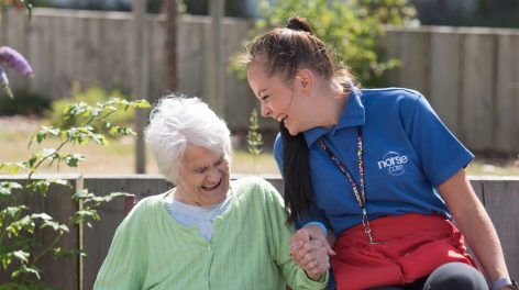 NorseCare employee laughing with an elderly resident in one of our Norfolk based residential homes